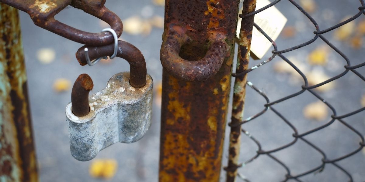 Broken lock on security fence - evidence of security failure that must be documented quickly